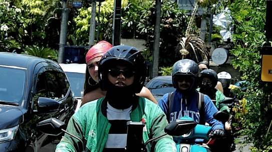 Motorcyclists travelling on the footpaths in Canggu. 