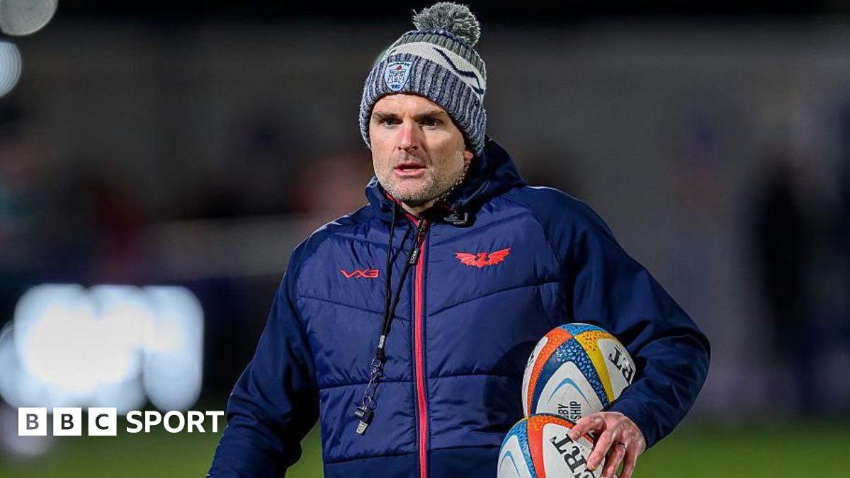 Scarlets defence coach Jared Payne carrying two rugby balls during a warm-up