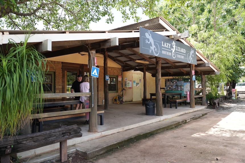 Building with wooden beams and a sign that says Lazy Lizard at the roof level