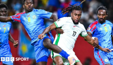 Dr Congo player challenging Nigeria's Chris Iwobi