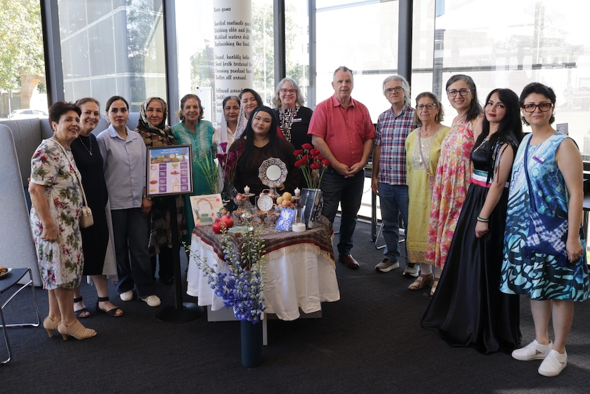 Librarian Leila Davandeh is pictured with people from the Iranian community at a Nowruz event in Wagga. 