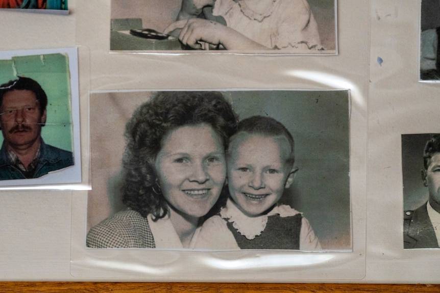 Black and white photograph of a woman smiling with a little boy