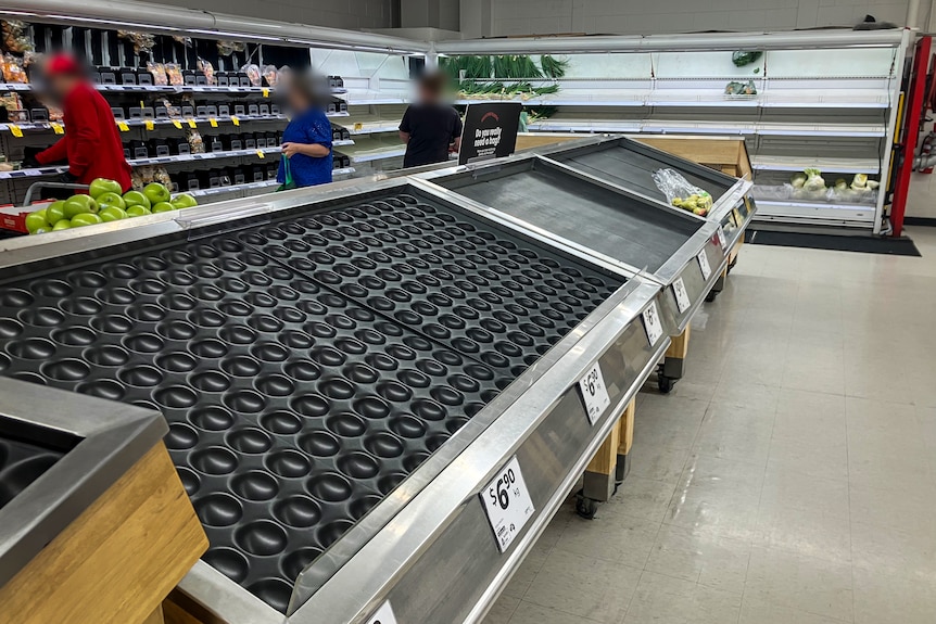Empty fruit shelves at a supermarket.