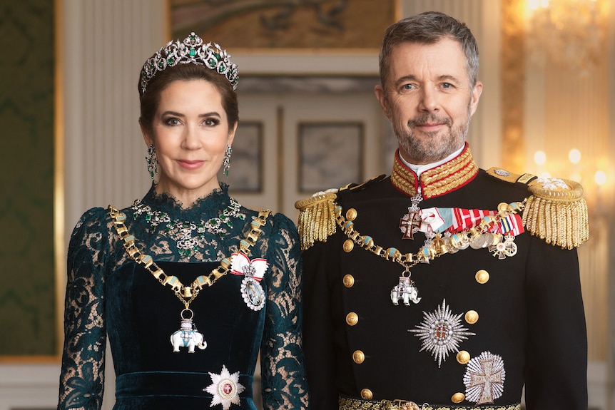 Queen Mary and King Frederick of Denmark smile standing side by side wearing royal attire.