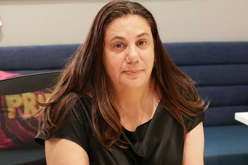 Woman holds photo of son
