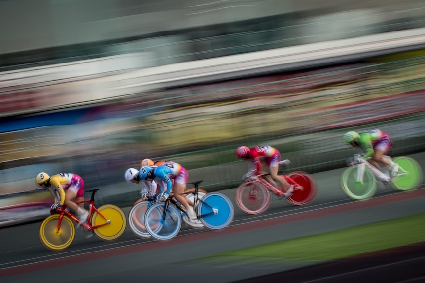 Keirin riders race in bright colours bibs and bikes