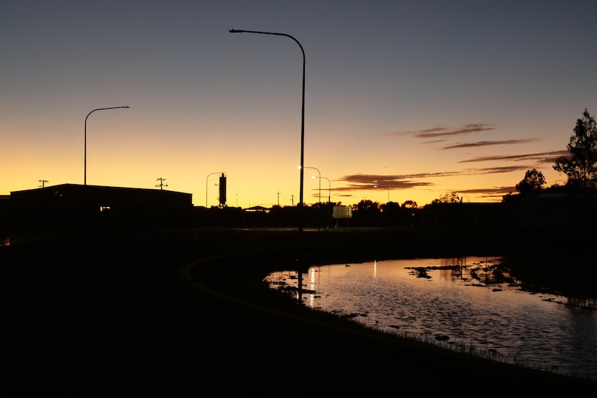 Sunrise looking towards Longreach with floodwater around road