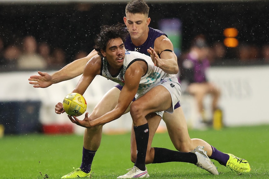 Jase Burgoyne prepares to make a handpass under pressure