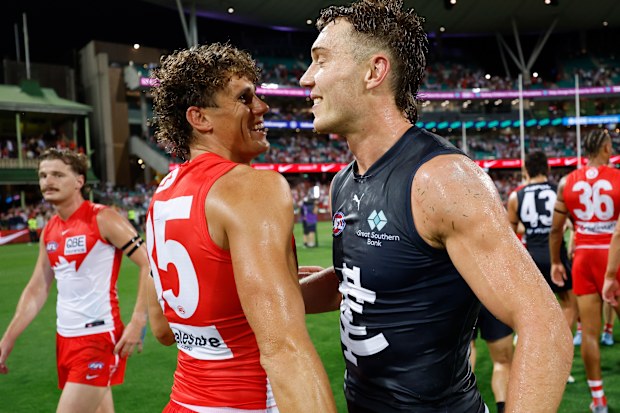 Charlie Curnow of the Swans and Patrick Cripps of the Blues embrace.