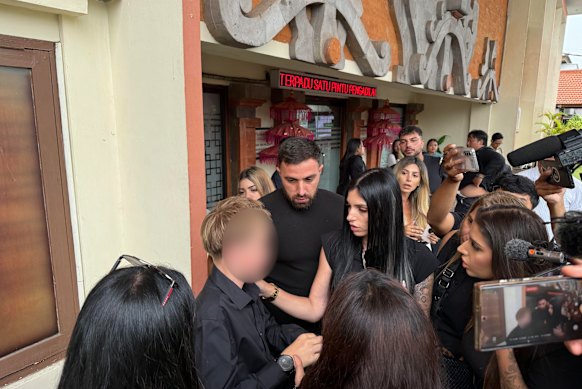Jazmyn Gourdeas (centre), the widow of Zivan Radmanovic, consoling one of their children outside court in Bali after the judges postponed the verdicts.