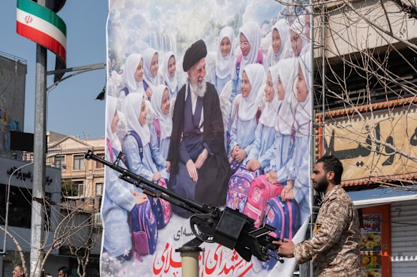 A soldier of the Islamic Revolutionary Guard Corps guards an area targeted in US-Israeli attacks in Tehran.