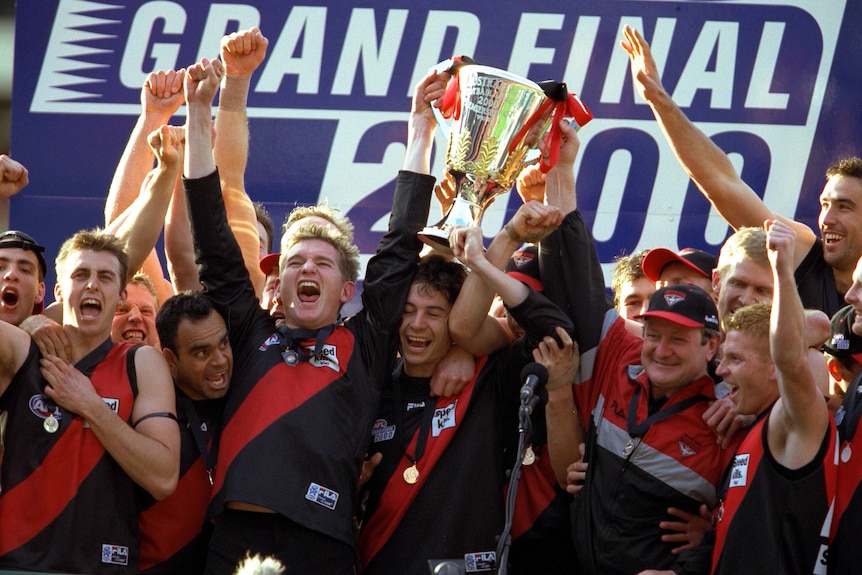 Essendon players celebrate the 2000 premiership win
