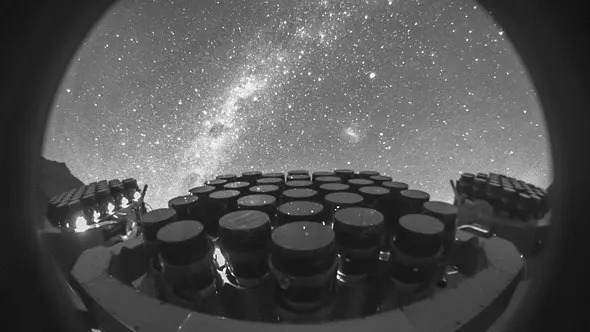 an array of lenses stacked in tight grids Sits below a starry sky