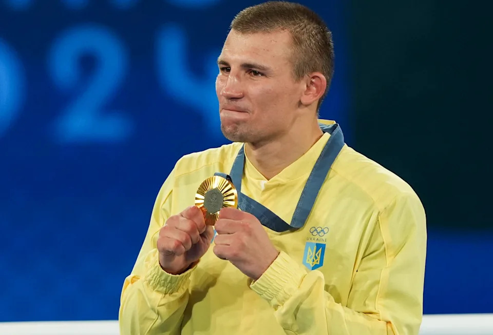 PARIS, FRANCE - AUGUST 07: Gold Medalist Oleksandr Khyzhniak of Team Ukraine poses on the podium during the Boxing Men's 80kg medal ceremony after the Boxing Men's 80kg Final match on day twelve of the Olympic Games Paris 2024 at Roland Garros on August 07, 2024 in Paris, France. (Photo by Mustafa Ciftci/Anadolu via Getty Images)