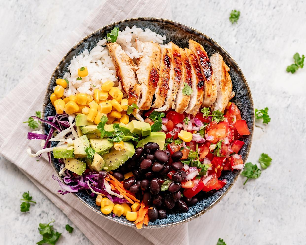 Magda Tymczyj/STOCK PHOTO/Getty Images - PHOTO: Stock photo of a grilled chicken salad with black beans, avocado and corn.