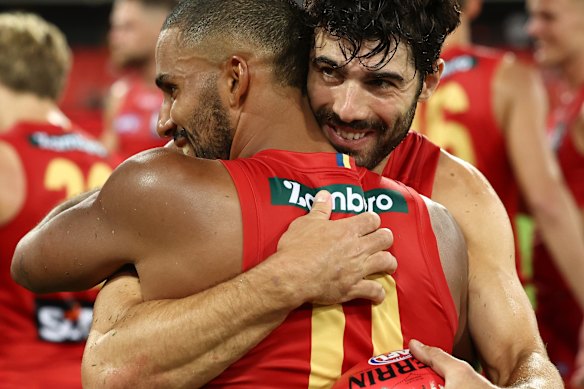 Petracca embraces teammate Touk Miller after the Norm Smith medallist’s stunning first game for the Suns.