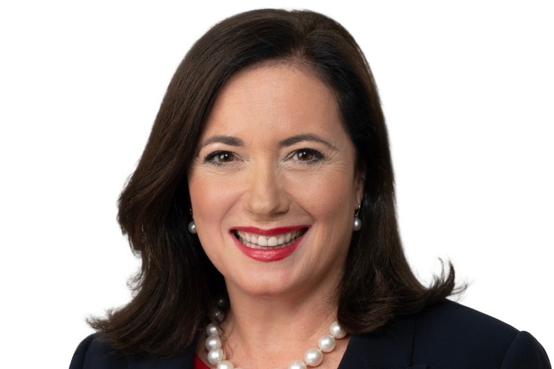 A middle-aged woman with dark hair smiles in a professional portrait photo.