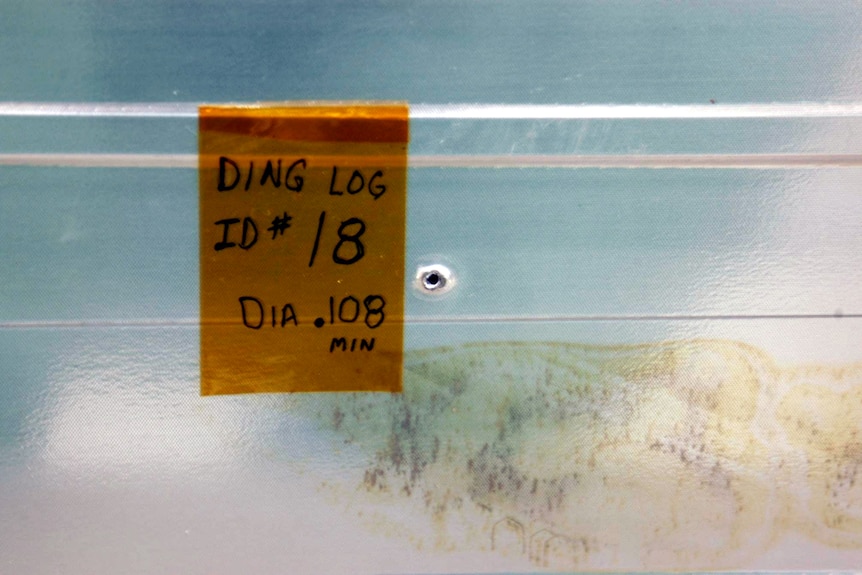 A puncture hole on a panel.