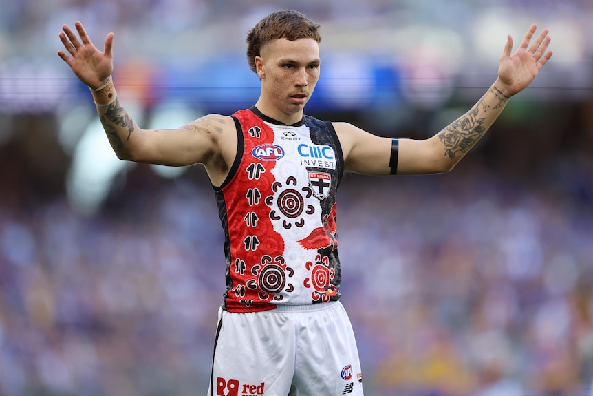 Lance Collard stands with both arms in the air during a St Kilda vs West Coast Eagles AFL match in 2025.