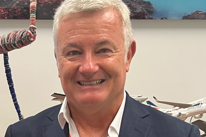 Adam smiles at camera.