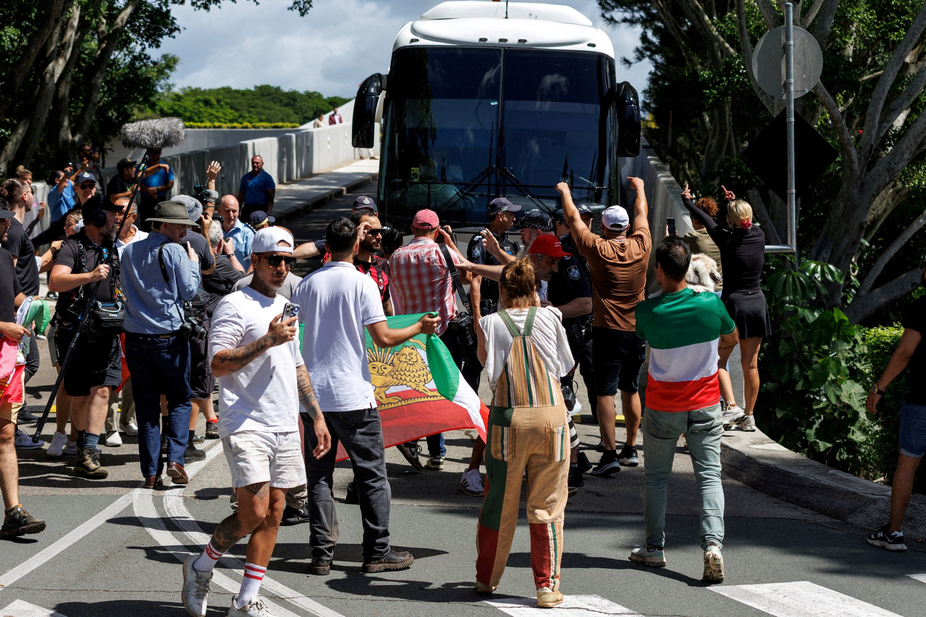 Protesters demonstrate outside of Royal Pines resort as a bus carrying players from the Iranian women's football team and staff departs, after five Iranian women football players were granted humanitarian visas, on the Gold Coast, Queensland, Australia, March 10, 2026. (Reuters Photo)