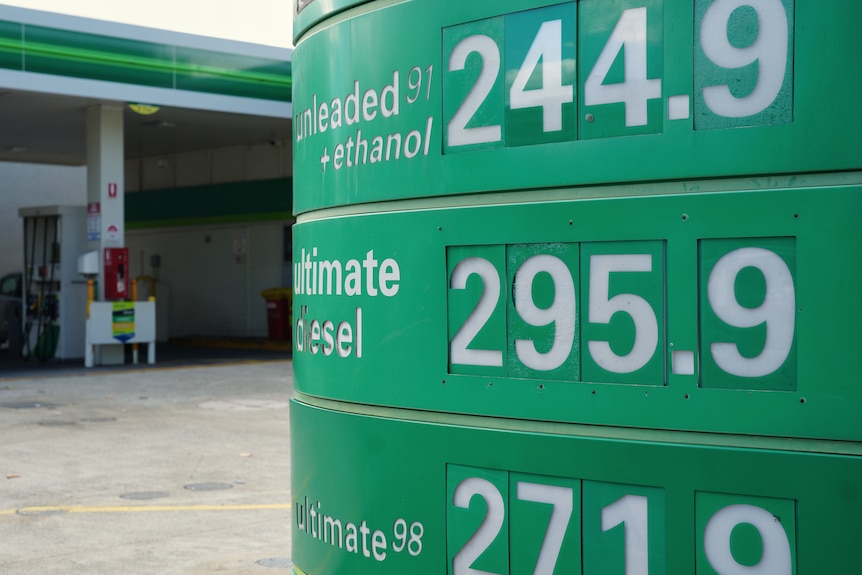 A sign outside a petrol station with prices about $2 per litre for all types.