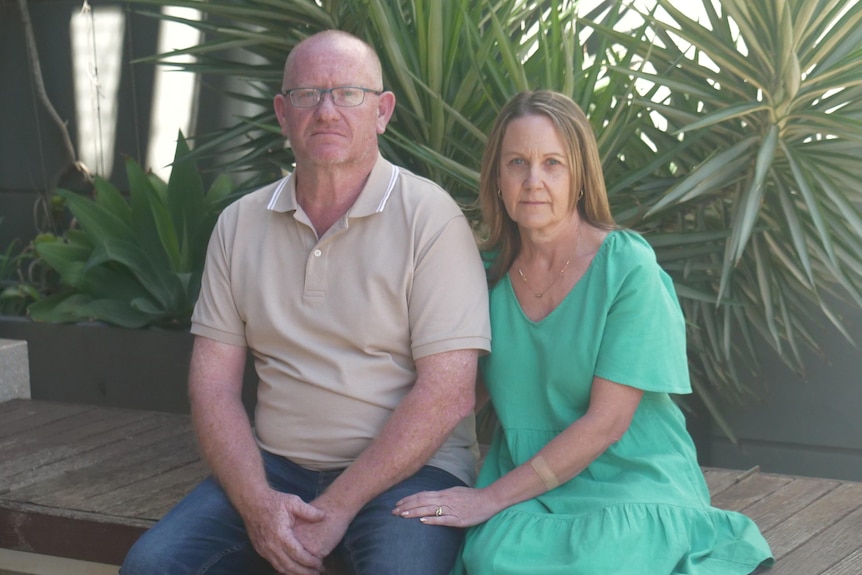 A man and a woman sitting side by side on a bench