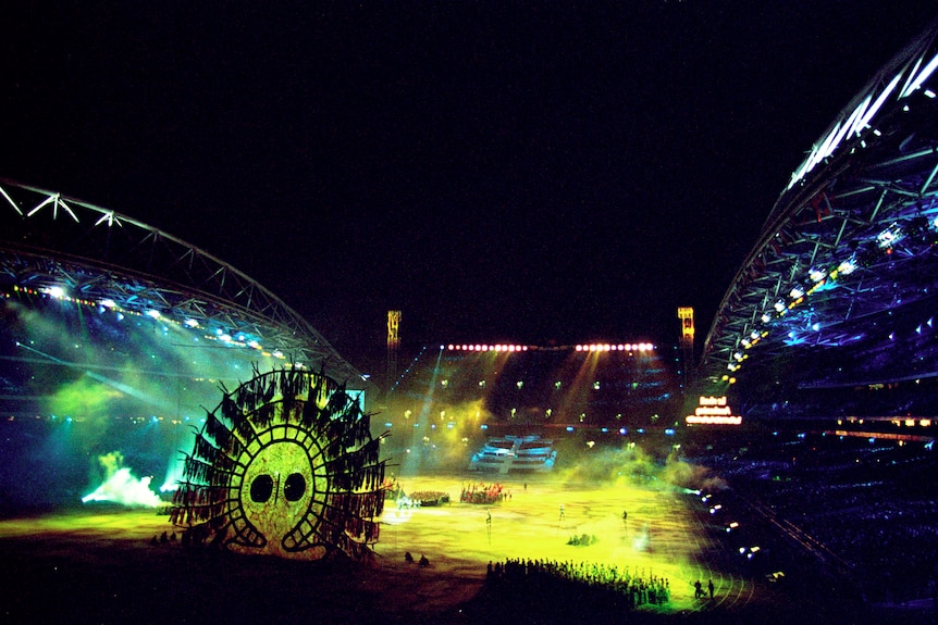 Image of the stadium at the olympic opening ceremony, large Indigenous artwork appears