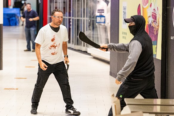 The safety glasses worn by participants and colourful guns are the only giveaway that the incident is staged.