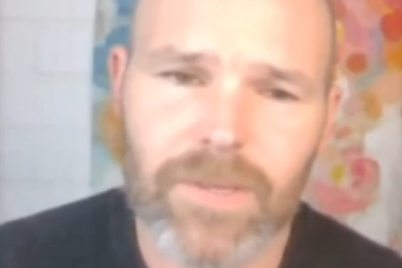 A man with a beard wearing a black shirt speaks with a caption saying "the Lord began to speak"