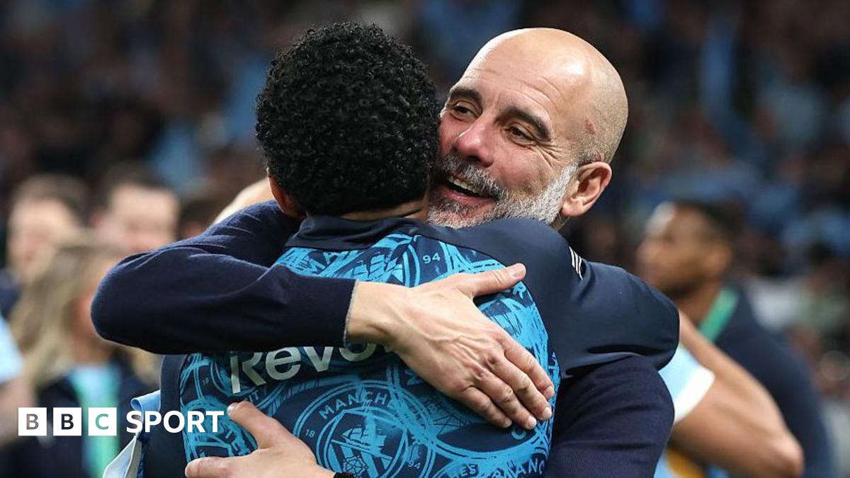 Pep Guardiola hugs his players