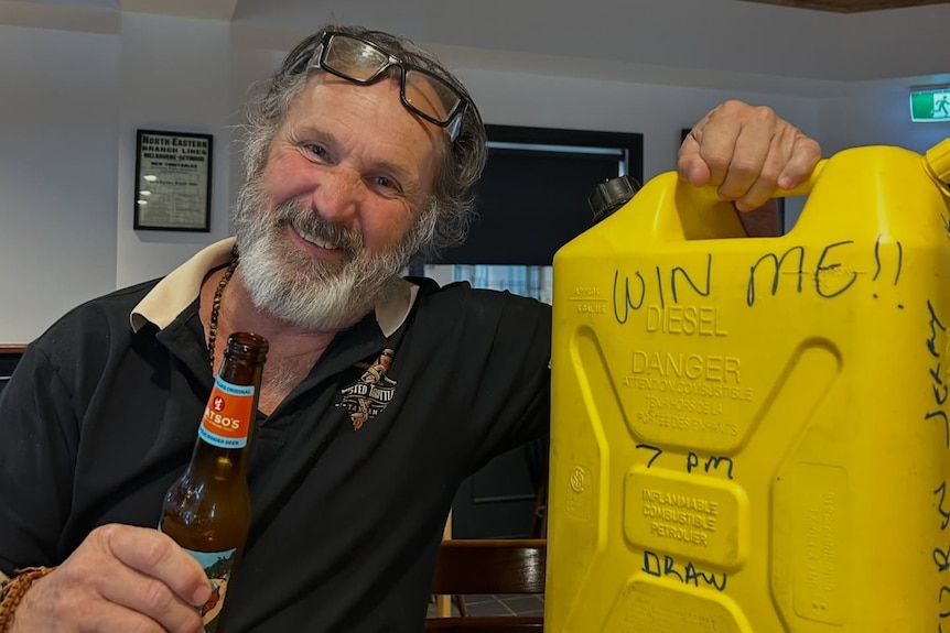 A man holding a jerry can of fuel