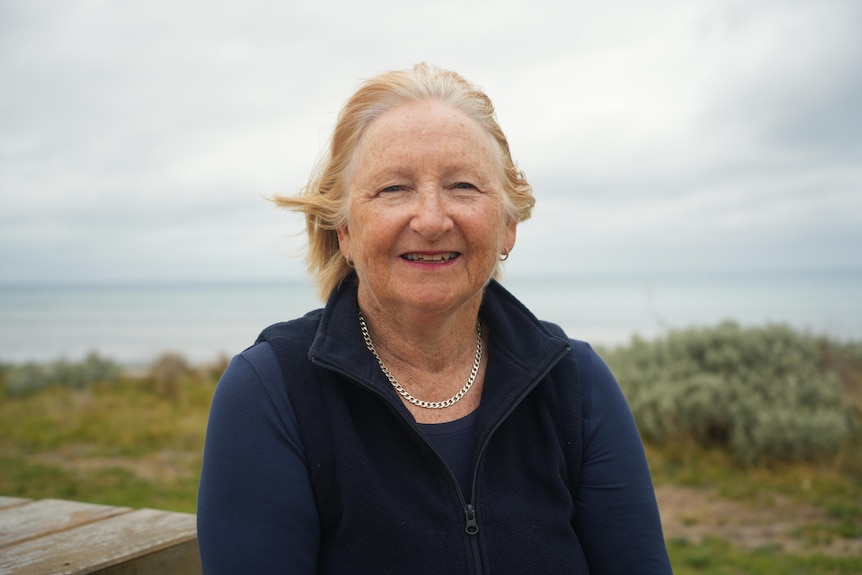 Vicki smiles at the camera.