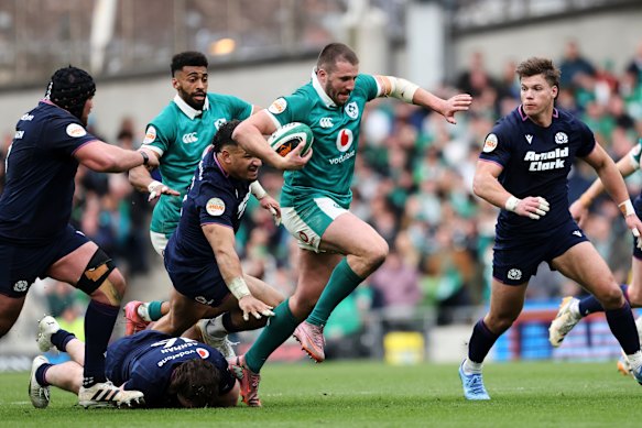 Giant Ireland centre Stuart McCloskey leaves Scotland opponents in his wake.