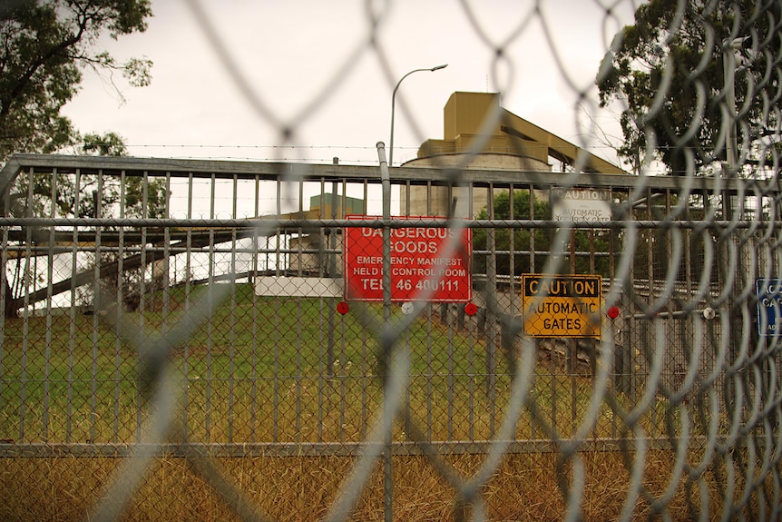 image of fence in foreground with a coal mind visible in background