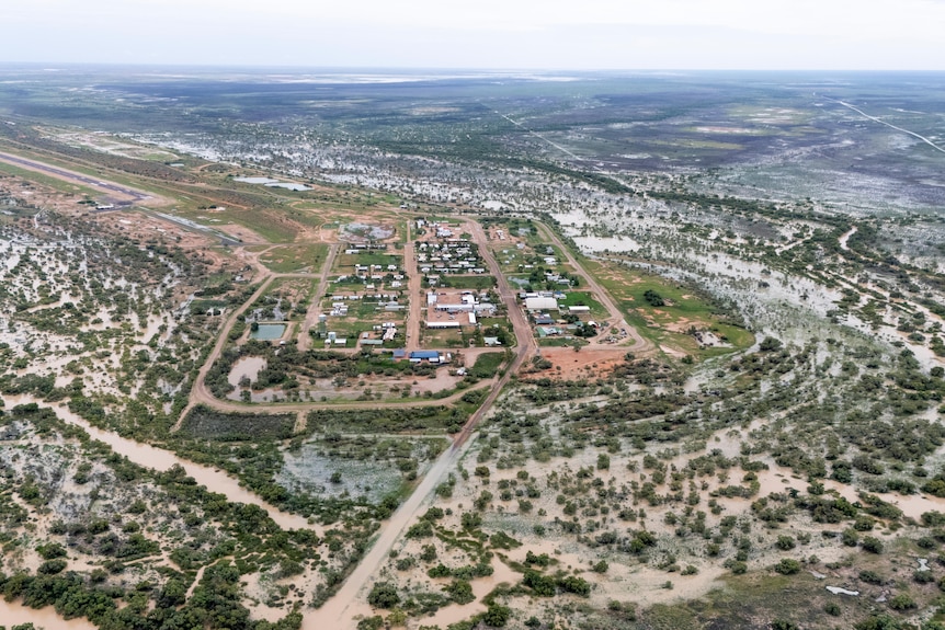 An aerial shot of an Outback town surrounded by wet ground and pooled floodwater