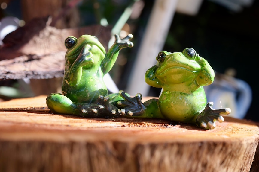 Two green frog statues.