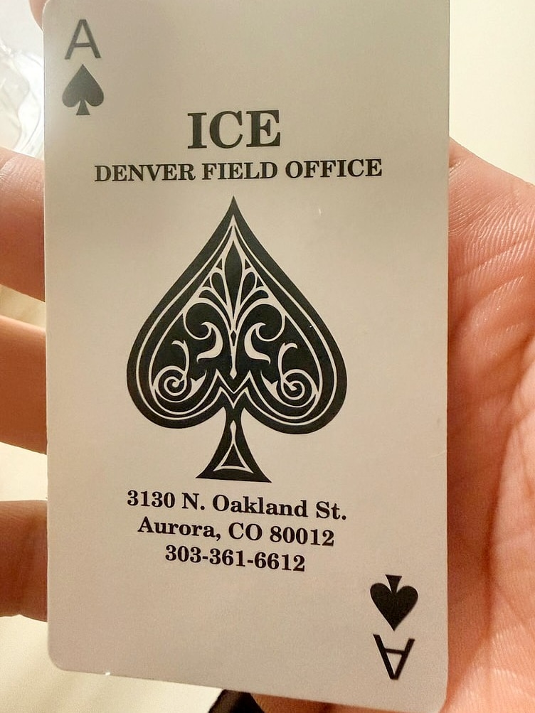 A card with the ace of spades on it and the address of an ICE detention centre.