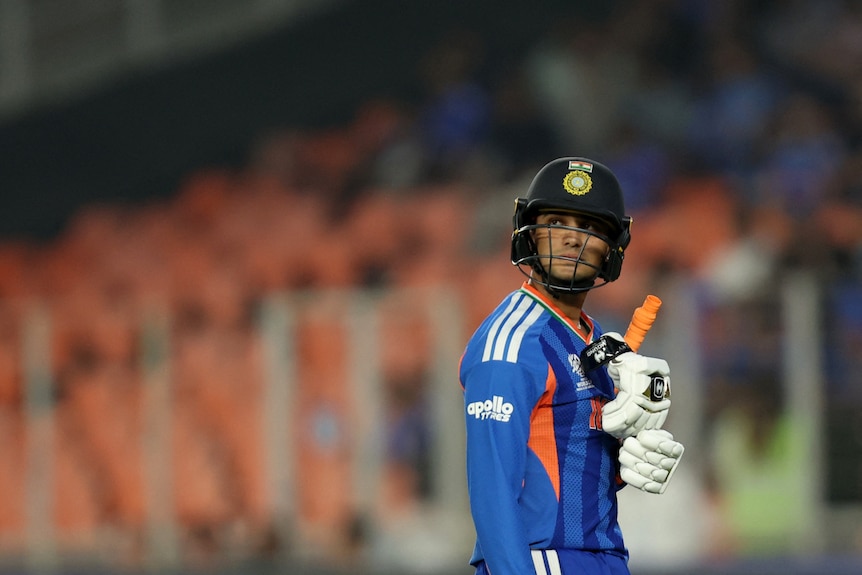 India's Abhishek Sharma walks back to the pavilion, looking over his shoulder