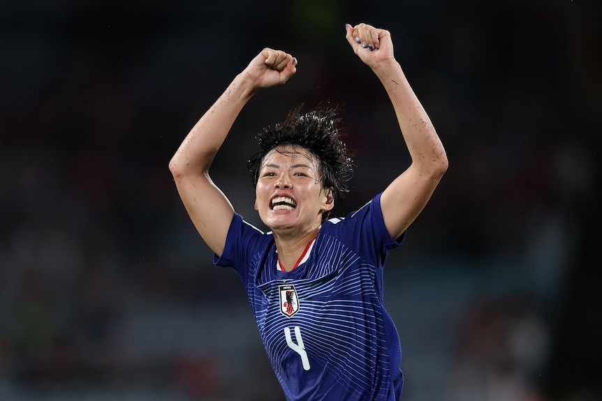A Japanese player celebrates scoring a goal