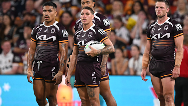 Broncos players react after the Panthers scored a try.
