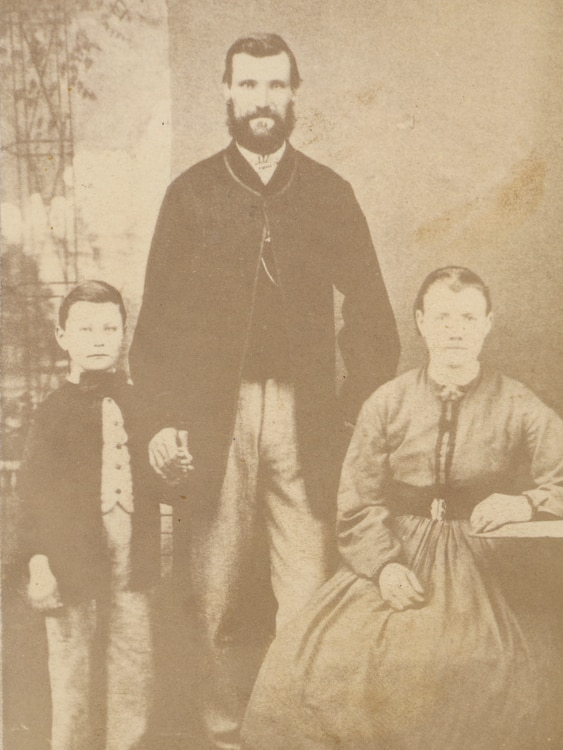 A man, woman and child in a sepia-toned photo