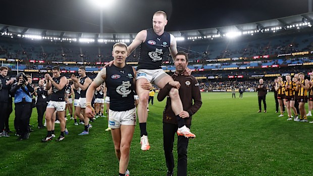 Sam Docherty is chaired off in his last game by Carlton's Patrick Cripps and long-time teammate Kade Simpson.
