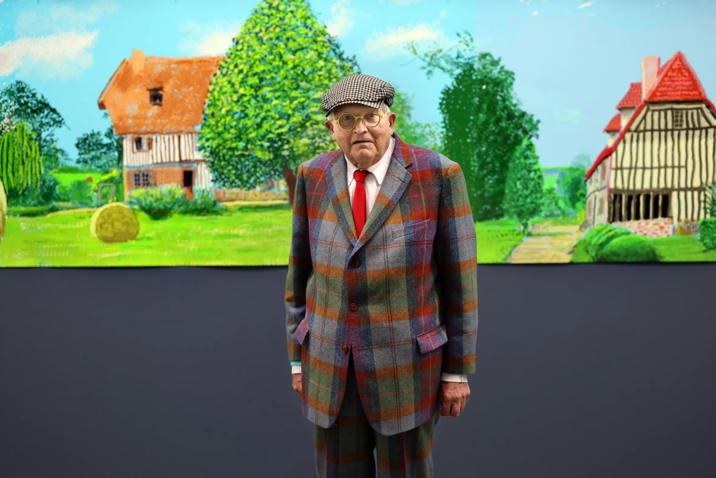 British painter David Hockney poses in front of his painting "A year in Normandy."