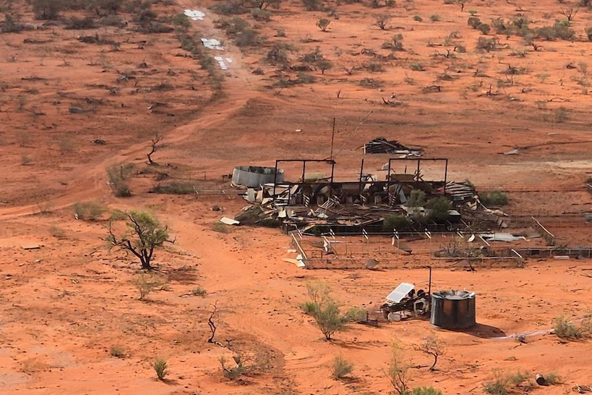 An aerial view of a damaged shed on an outback station.