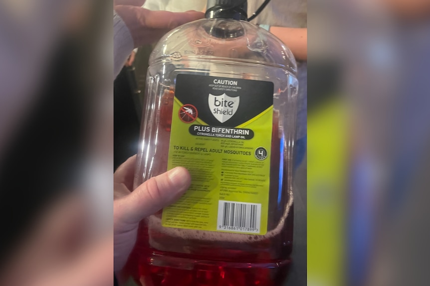 A plastic bottle full of insect repellent liquid.