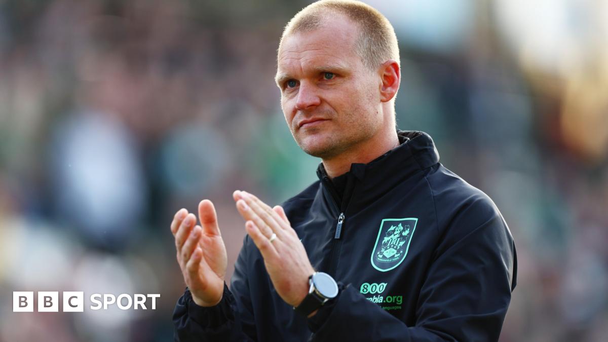 Huddersfield Town boss Liam Manning claps the club's fans after a 3-1 defeat at Plymouth in League One