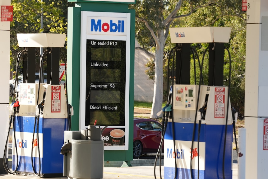 A petrol station with handwritten signs on every pump reading "no fuel".