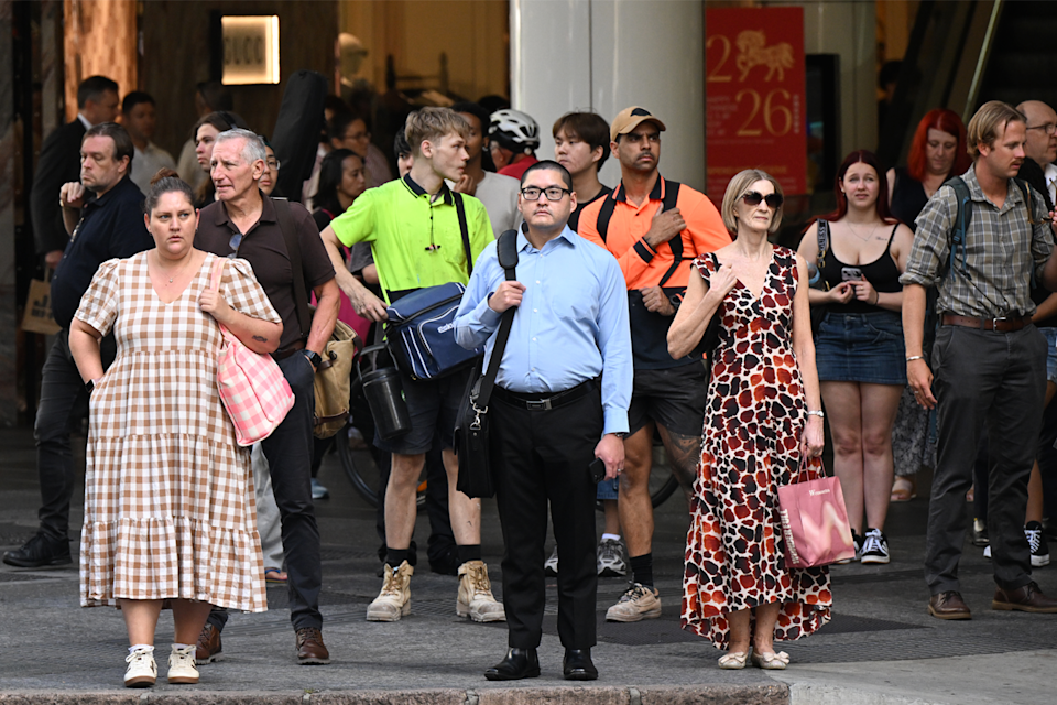 Australian workers pictured in the busy street.