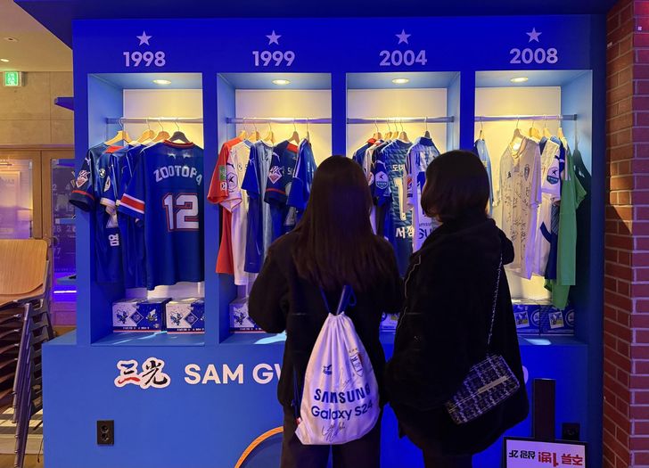 Suwon Samsung Bluewings fans browse through the football club's uniforms at Samgwang, a supporters' pub run by a fan of the team in Suwon, Gyeonggi Province, Feb. 28. Korea Times photo by Lee Hae-rin